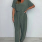 V-ringad enfärgad jumpsuit med lös midja för kvinnor